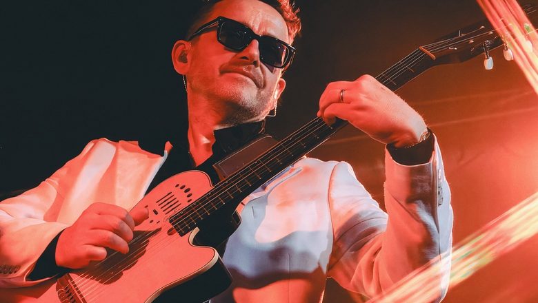Reuben Barrett playing guitar on stage